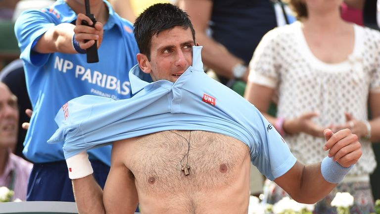 Serbia's Novak Djokovic changes shirt between two games against Spain's Rafael Nadal during the French tennis Open men's final match at the Roland Garros s