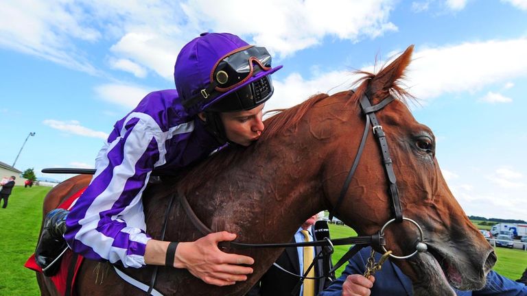 There's a kiss from the winning rider...
