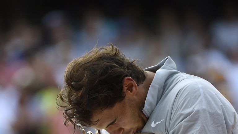 Spain's Rafael Nadal kisses the Musketeers trophy after winning the French tennis Open men's final match against Serbia's Novak Djokovic at the Roland Garr