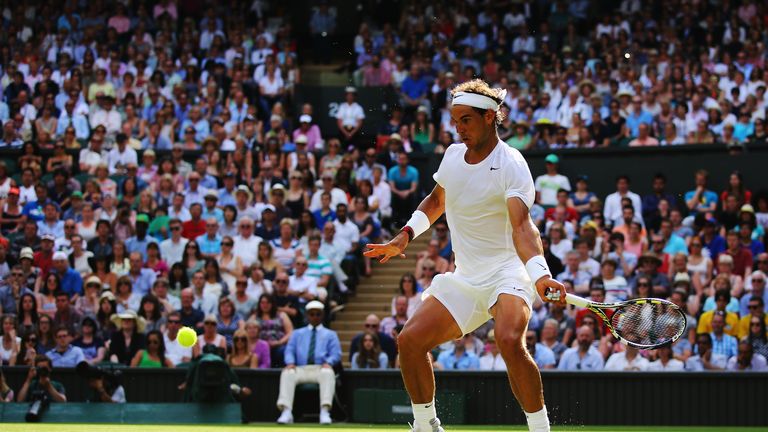 Rafael Nadal plays a forehand in the first round of Wimbledon 2014