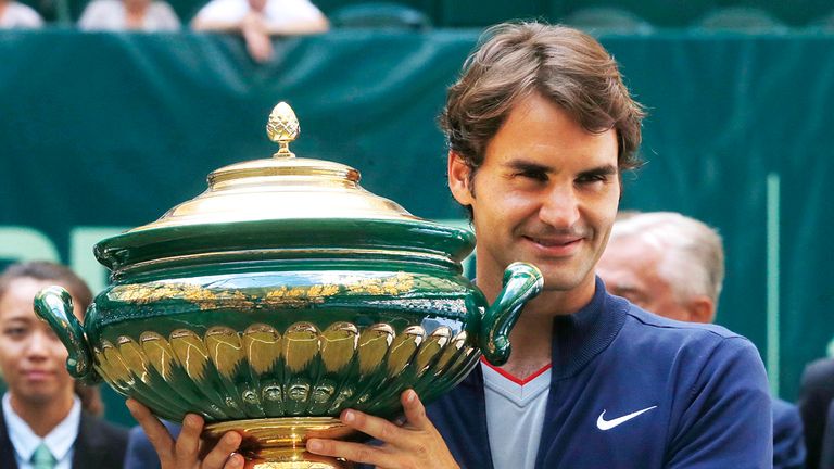 Switzerland's Roger Federer holds the trophy after winning the final of the Gerry Weber Open tennis tournament in Halle