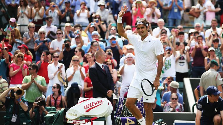 Roger Federer celebrates after his first round match at Wimbledon 2014