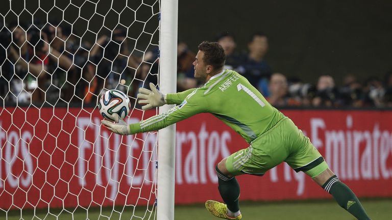 Russia's goalkeeper Igor Akinfeev fumbles the ball into his own net