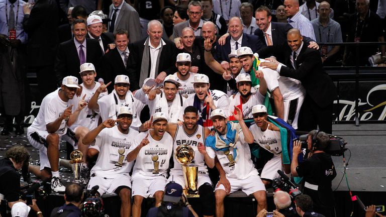 The San Antonio Spurs celebrate with the Larry O'Brien trophy after defeating the Miami Heat to win the 2014 NBA Finals 