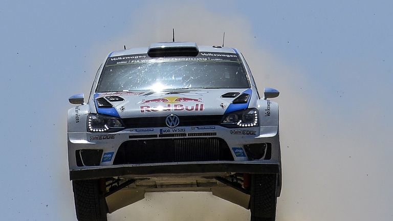 French driver Sebastien Ogier and his compatriot co-driver Julien Ingrassia jump their Volkswagen Polo R 