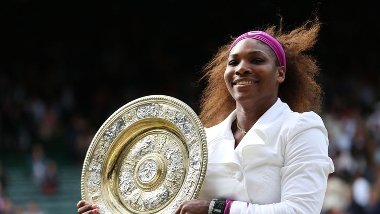 Serena Williams of the USA lifts the Wimbledon trophy in 2 012