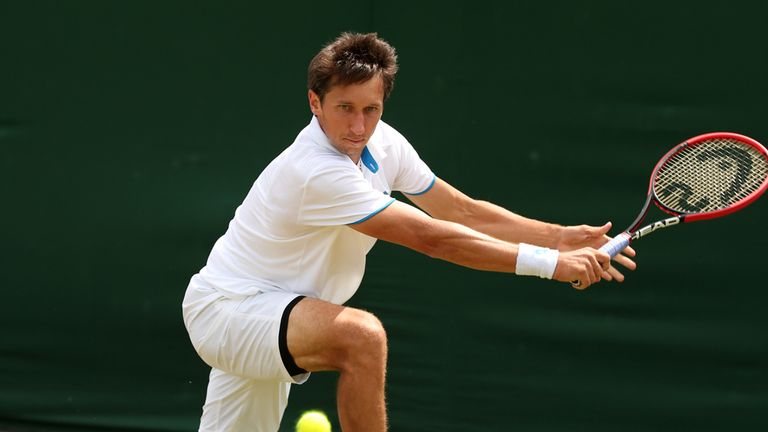 Ukraine's Sergiy Stakhovsky returns to Latvia's Ernests Gulbis during their men's singles second round match on day three of  Wimbledon 2014