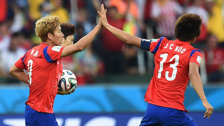 South Korea's midfielder Son Heung-Min (L) celebrates with forward Koo Ja-Cheol after scoring his team's first goal during the Group H