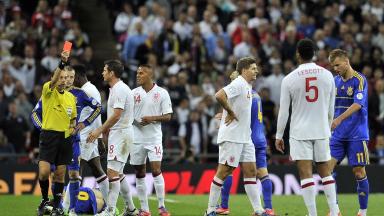 Steven Gerrard (3rd R) captain of England walks from the field after receiving a red card from referee Cuneyt Cakir (L) during the 2014 qualifier
