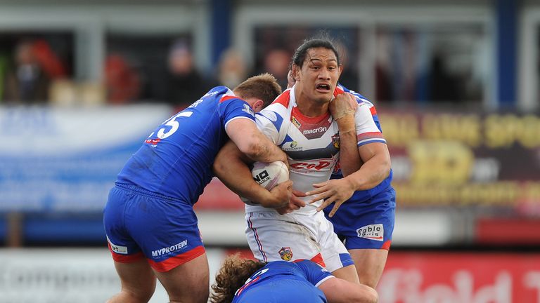 Wakefield Wildcats forward Taulima Tautai is tackled by St Helens trio Anthony Walker, Kyle Amor and Anthony Laffranchi