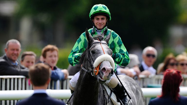 Ryan Moore and The Grey Gatsby return to the winner's enclosure after the Prix Du Jockey-Club.
