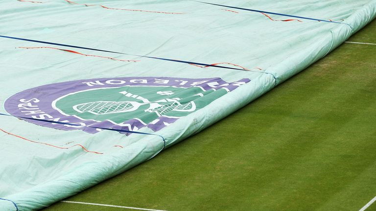 LONDON, ENGLAND - JUNE 27:  The rain covers are taken of a court on day five of the Wimbledon Lawn Tennis Championships at the All England Lawn Tennis and 