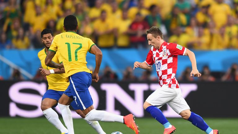 Luka Modric of Croatia controls the ball against Hulk (L) and Luiz Gustavo of Brazil in the first half during the 2014 FIFA World Cup match