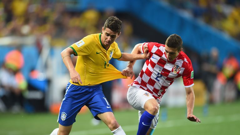 Oscar of Brazil fights off Sime Vrsaljko in the first half during the 2014 FIFA World Cup Group A match against Croatia
