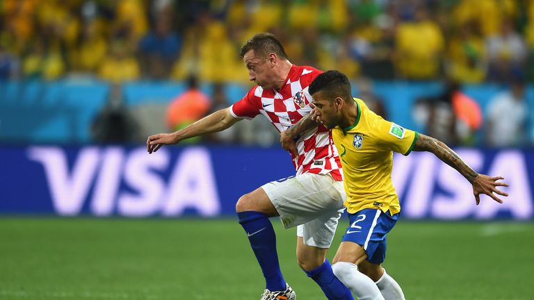 Dani Alves of Brazil challenges Ivica Olic of Croatia in the first half during the 2014 FIFA World Cup Brazil Group A match