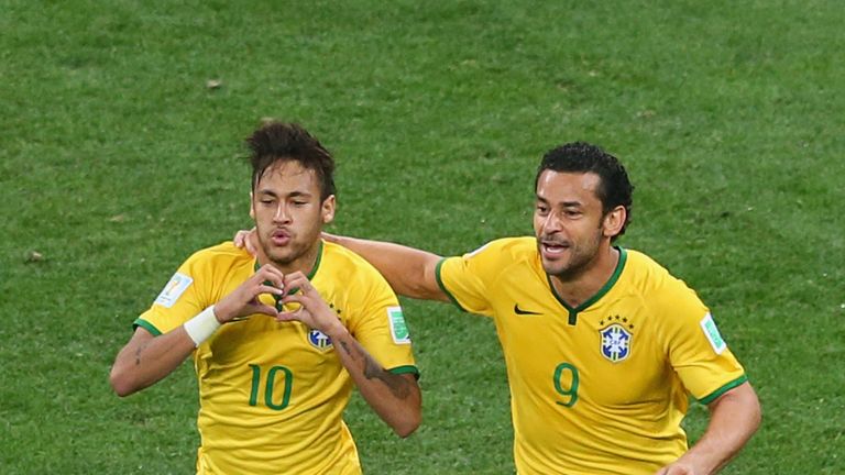 Neymar of Brazil (L) celebrates with Fred after scoring a goal in the first half during the 2014 FIFA World Cup match against Croatia