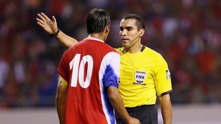 Referee Marco Antonio Rodriguez Moreno of Mexico converses with Bryan Ruiz #10 during the FIFA 2014 World Cup Qualifi