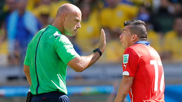Referee Howard Webb speaks with Chile's Gary Medel during the World Cup round of 16 soccer match between Brazil and Chile