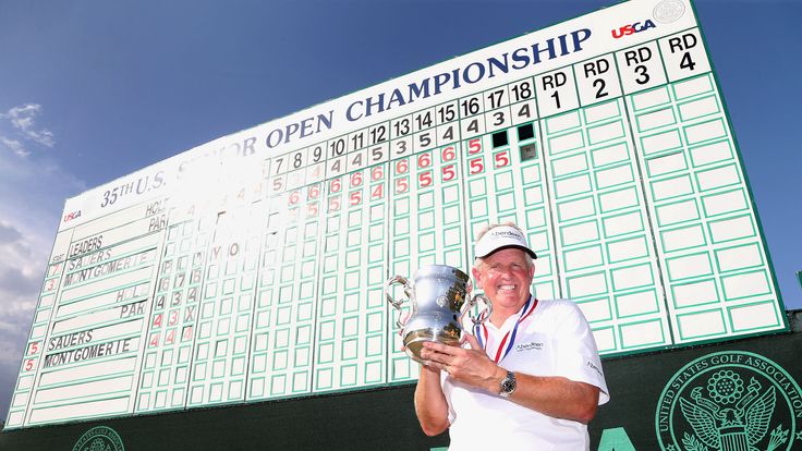 Colin Montgomerie poses with the winner's trophy after winning the 2014 US Senior Open Championship in the final round