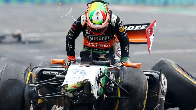 Sergio Perez climbs out of his wrecked Force India after crashing at the conclusion of the Canadian GP