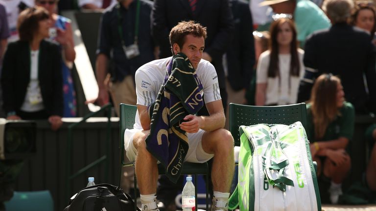 Britain's Andy Murray sits down after losing his men's singles quarter-final match against Bulgaria's Grigor Dimitrov on day nine of the 2014 Wimbledon Cha