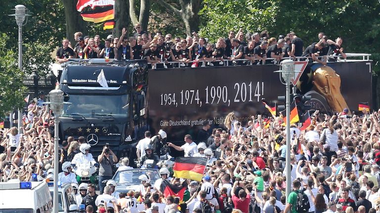 German fans cheer on the German national team as they head to the Brandenburg Gate
