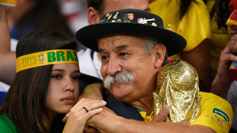 Fans of Brazil reacts after their team lost the semi-final football match between Brazil and Germany at The Mineirao Stadium