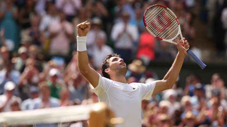 Bulgaria's Grigor Dimitrov celebrates winning his men's singles quarter-final match against Britain's Andy Murray on day nine of the 2014 Wimbledon Champio