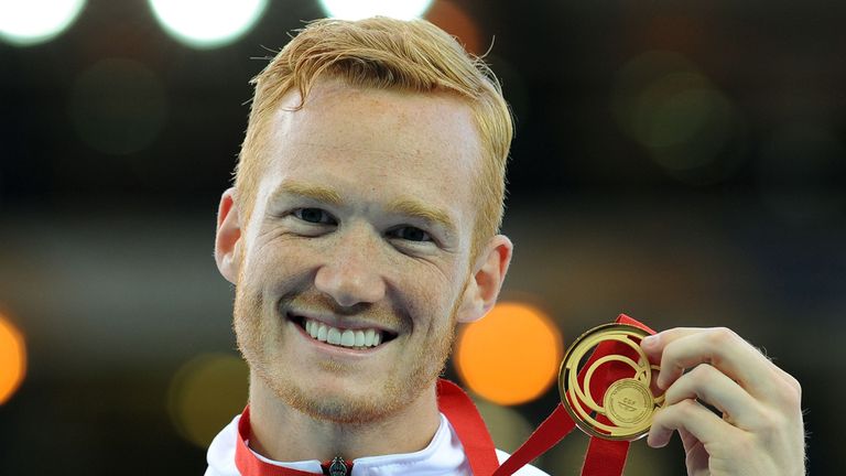 England's Greg Rutherford celebrates with his gold medal for the Men's Long Jump at Hampden Park