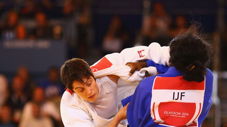 Sarah Clark of Scotland on her way to winning gold in the Women's -63kg Gold Medal Contest against Helene Wezeu Dombeu