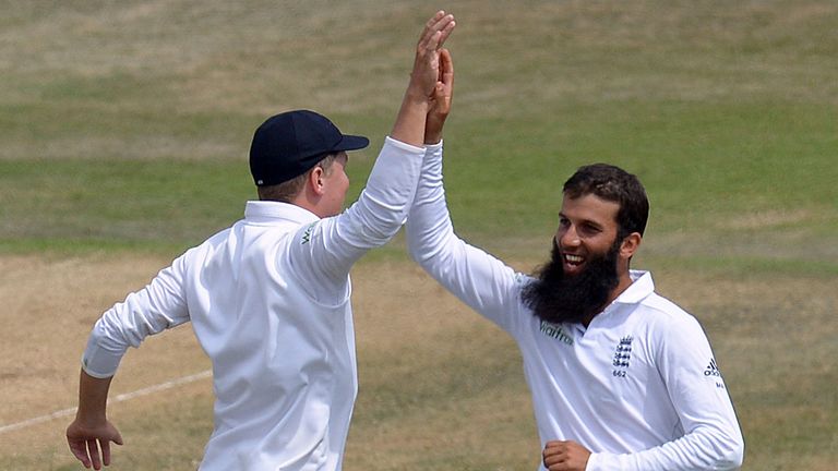 England's Moeen Ali celebrates with team mate Gary Ballance after taking the wicket of India's Mohammed Shami (not pictured) claiming his fifth wicket