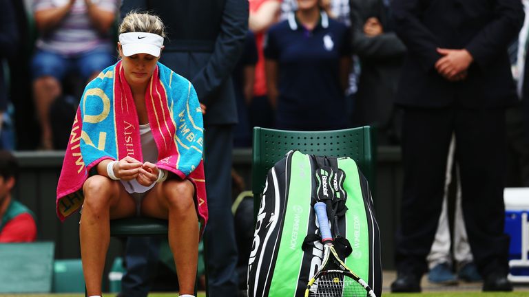 Eugenie Bouchard of Canada sits dejected after losing the Ladies' Singles final match against Petra Kvitova at Wimbledon