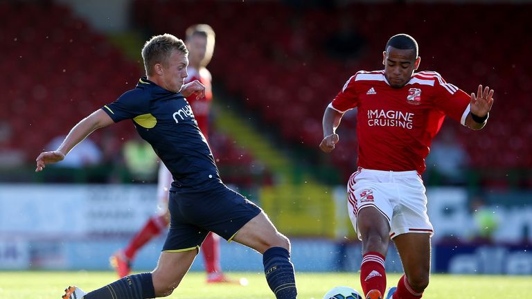 James Ward-Prowse of Southampton (L) in action with Louis Thompson of Swindon 