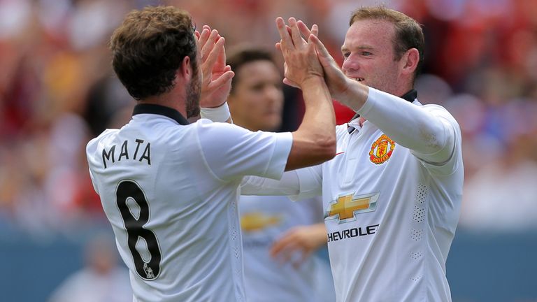 Wayne Rooney of Manchester United celebrates his second goal with Juan Mata