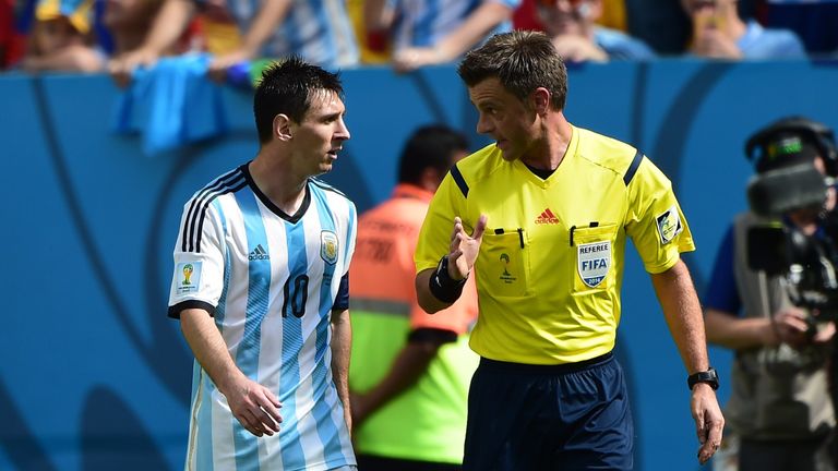 Lionel Messi speaks with Italian referee Nicola Rizzoli