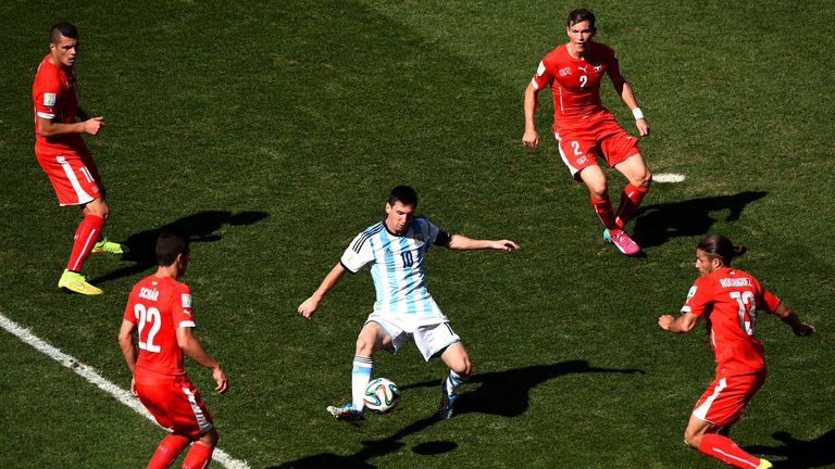 Lionel Messi is surrounded by four Switzerland players as he controls the ball