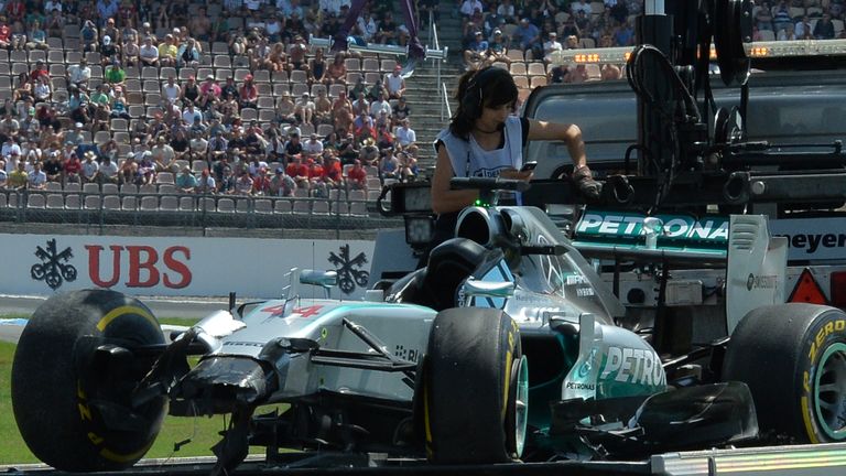 Lewis Hamilton's car is transported back to the garage after crashing during qualifying