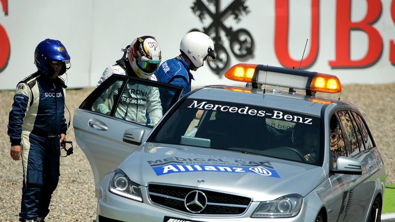 Lewis Hamilton gets in the medical car