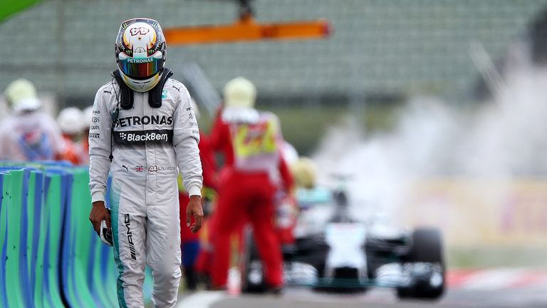 Lewis Hamilton walks away from his burning car