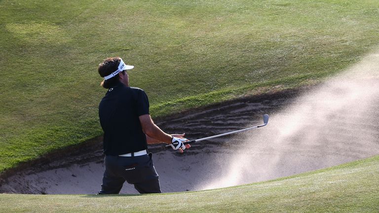 Bubba Watson of the United States hits from a bunker on the 18th hole during the first round of The 143rd Open Championship