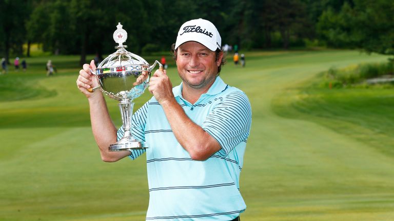 Tim Clark of South Africa holds the trophy after winning the RBC Canadian Open at the Royal Montreal Golf Club