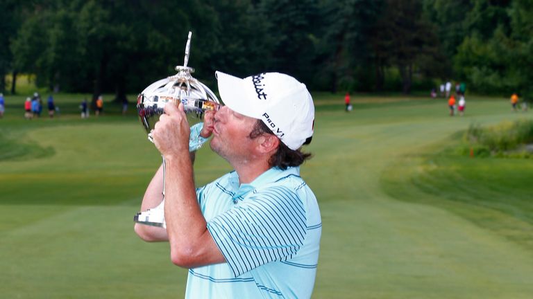 Tim Clark of South Africa kisses the trophy after winning the RBC Canadian Open at the Royal Montreal Golf Club 