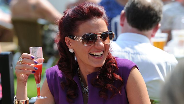 Racegoers have a drink in the sunshine during the 55th John Smith's Cup day of the 2014 John Smith's Cup Meeting at York Racecourse, York. PRESS ASSOCIATIO