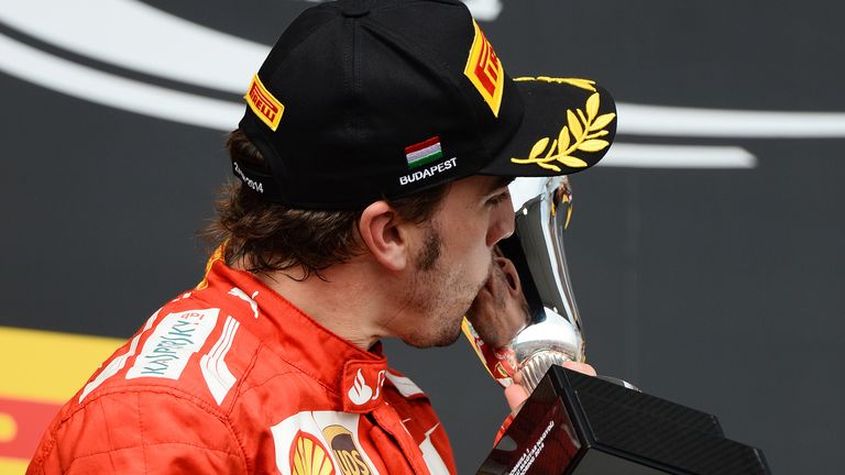 Fernando Alonso kisses his trophy