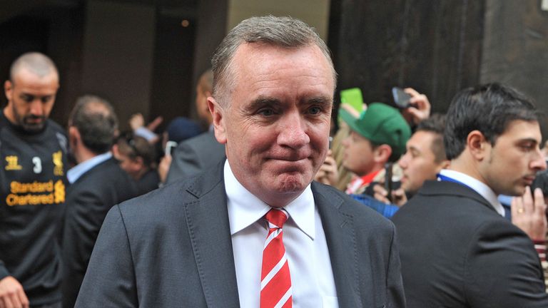 Liverpool Managing Director Ian Ayre (R) leads players onto a bus for a football training session in Melbourne on July 22, 2013. 