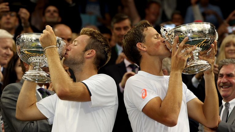 LONDON, ENGLAND - JULY 05:  Jack Sock of the United States (l) and Vasek Pospisil of Canada celebrate by kissing the winner trophies after winning the Gent