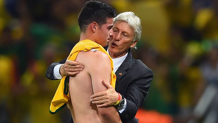 Head coach Jose Pekerman consoles James Rodriguez following Colombia's 2-1 defeat by Brazil on Friday