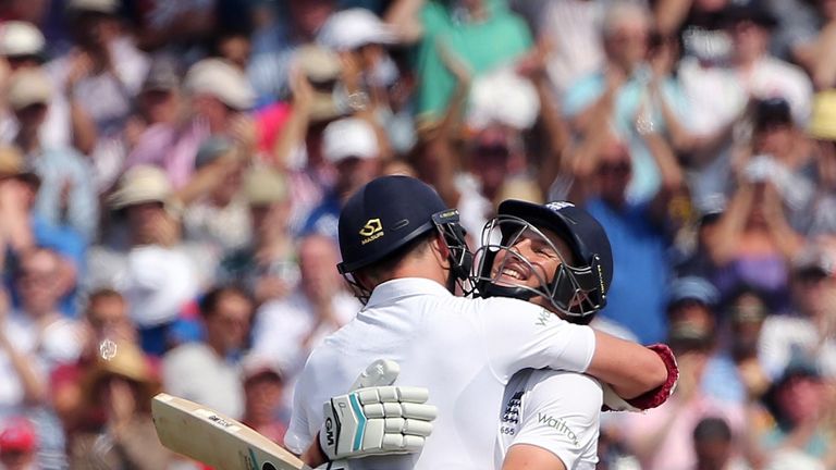England's Joe Root (R) celebrates reaching a century  with England team mate James Anderson (L)