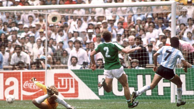 Argentina midfielder Jorge Burruchaga (R) beats West Germany goalkeeper Harald Schumacher to score the winning goal during the World Cup final in 1986