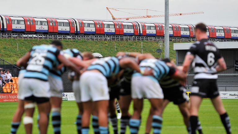A tube train passes by during the Super League match between London Broncos and Widnes Vikings at The Hive